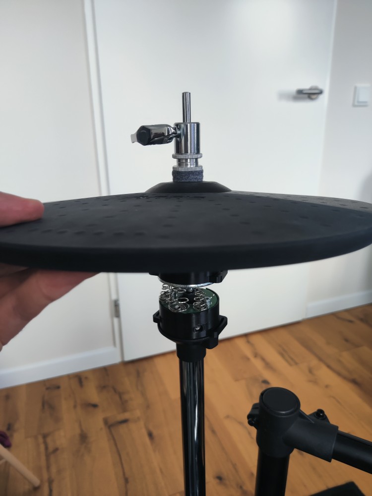 Lowering cymbal onto stand